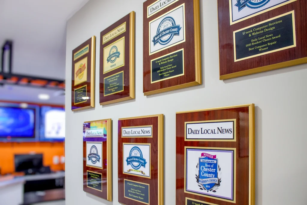 Awards and customer service recognition displayed inside U-neek Computer Services, an award-winning computer repair shop serving Downingtown and Chester County